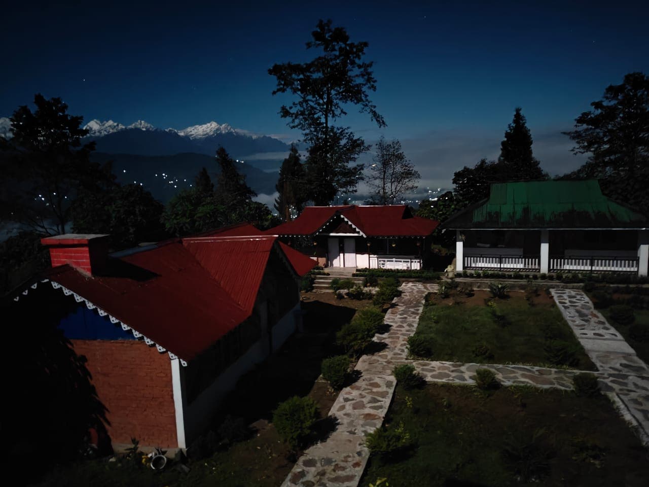 Red-roofed cottages with Kanchenjunga in moonlight