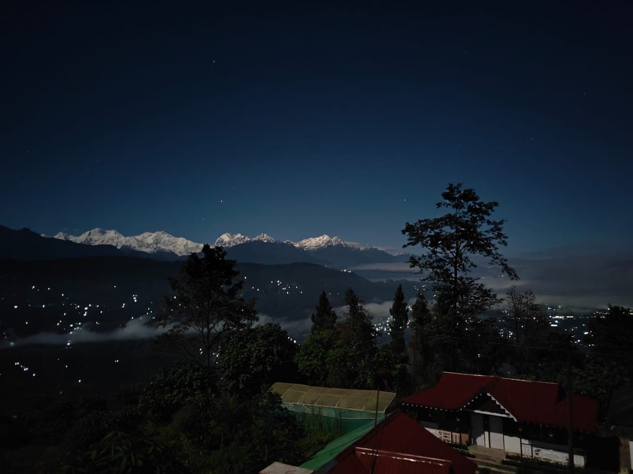 Kanchenjunga at night with valley lights below